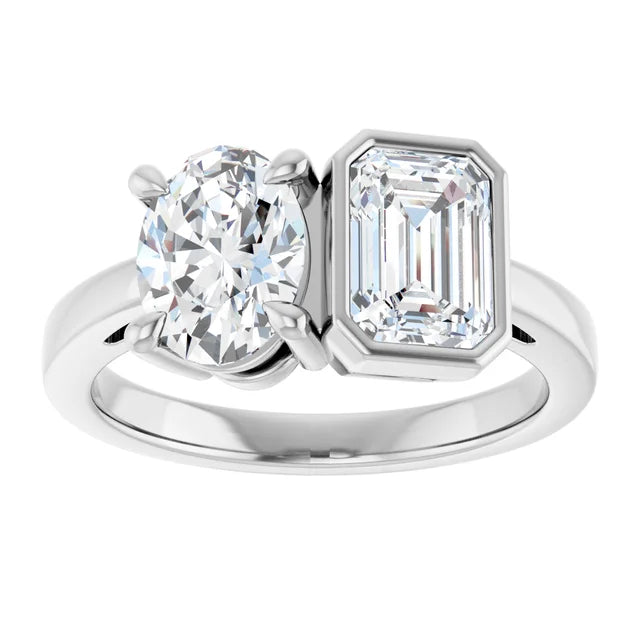 Diamond ring with round and emerald-cut diamonds on a white background